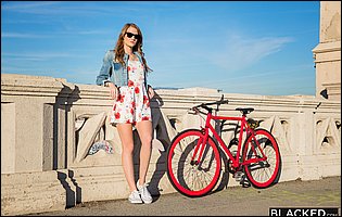 Ashley Lane in beautiful dress and denim jacket poses outdoor