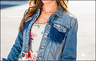 Ashley Lane in beautiful dress and denim jacket poses outdoor