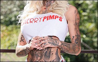 Hot tattooed blonde Chantal Danielle in t-shirt, panties and sexy heels poses outdoor