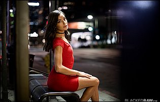 Emily Willis poses in red dress and white sneakers