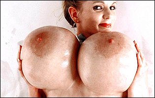 Keisha Evans shows off her huge oiled up boobs